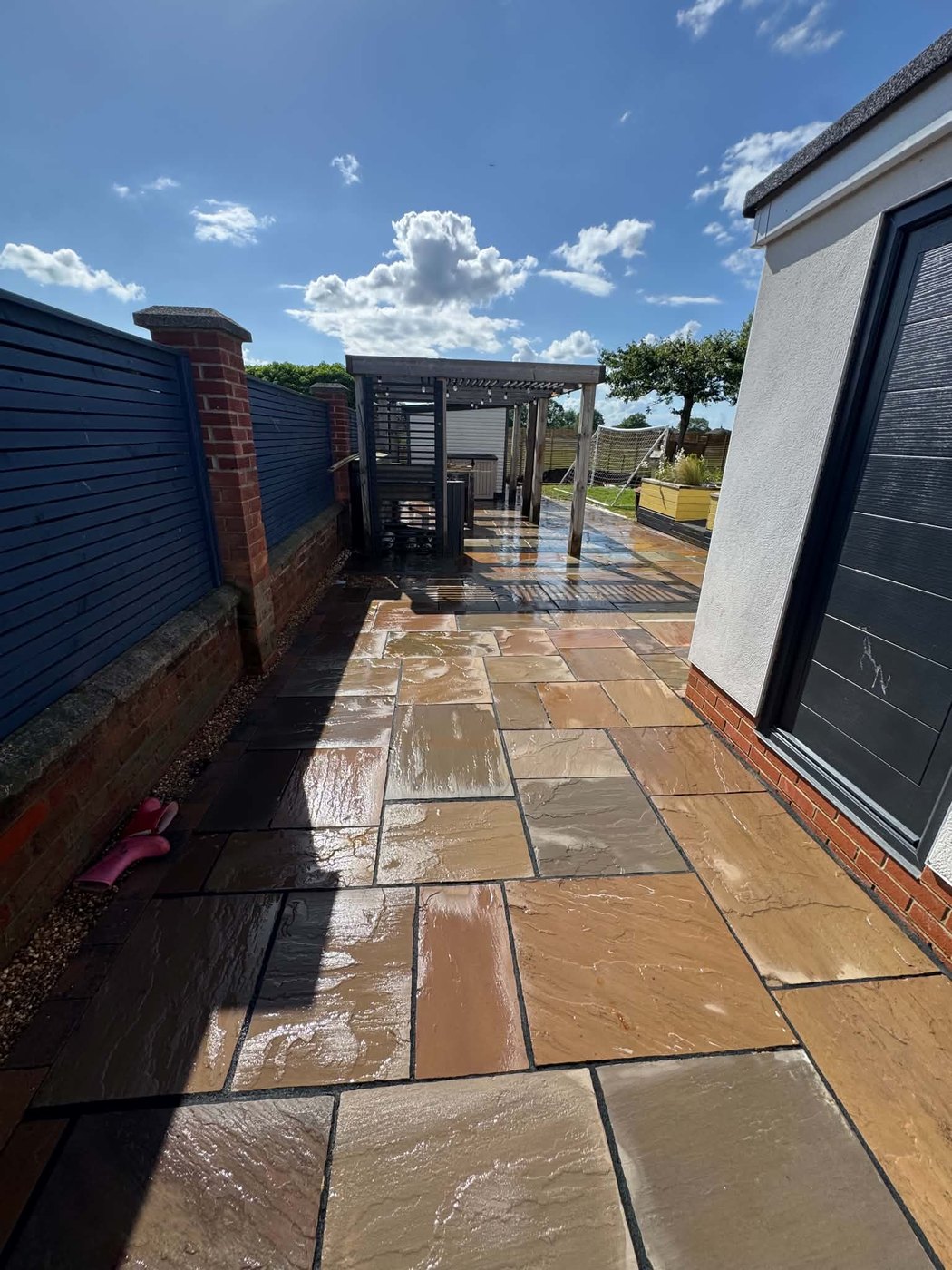 After — the sandstone patio jet-washed, colour restored